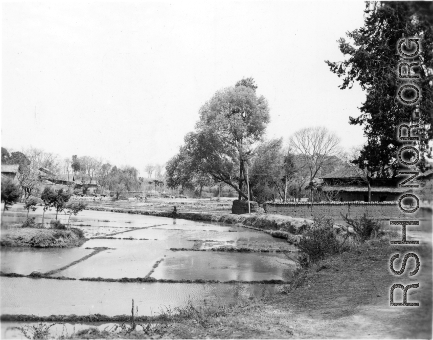 A village and flooded rice paddy in Yunnan province, China. During WWII.