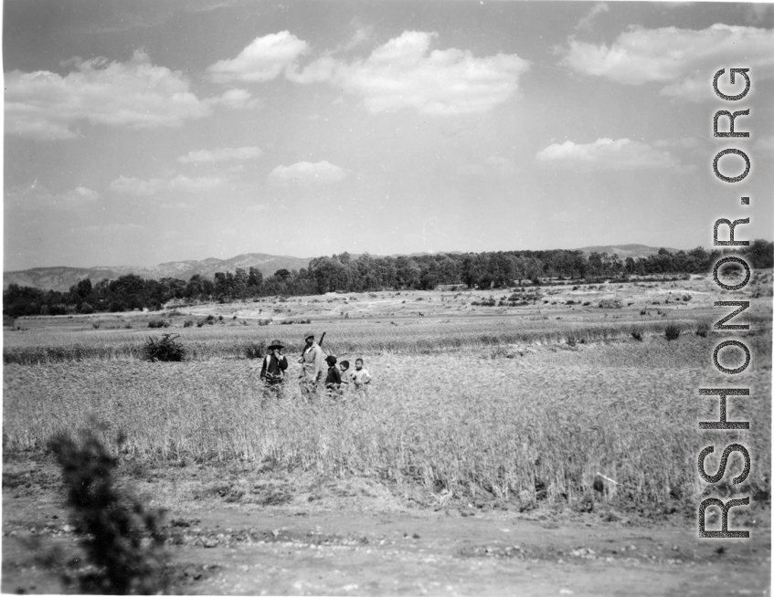 An American GI and local kids in a grain field in Yunnan province, China. During WWII.