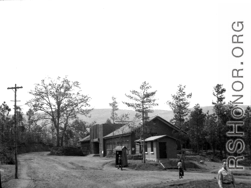 "'Last Resort' entertainment hall in Yangkai. Here the U.S. movie stars came and many time the programs were held inside. It had a stage and auditorium. An outside stage would be erected for the performances when a large crowd was present. It would be built at the same level as the stairs in the foreground, the GI's would be seated on the ground around the stage. The entertainment was sponsored by the U.S.O. The building was erected by the Chinese."