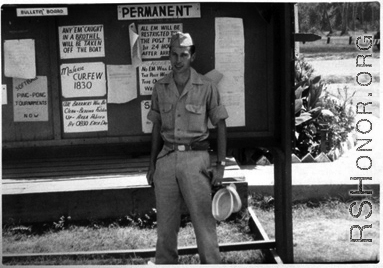 Henry Weiss of Brooklyn, NY; Tec 4, 219th Signal Depot Company, standing before a bulletin board at Tollygunge, India, during WWII.