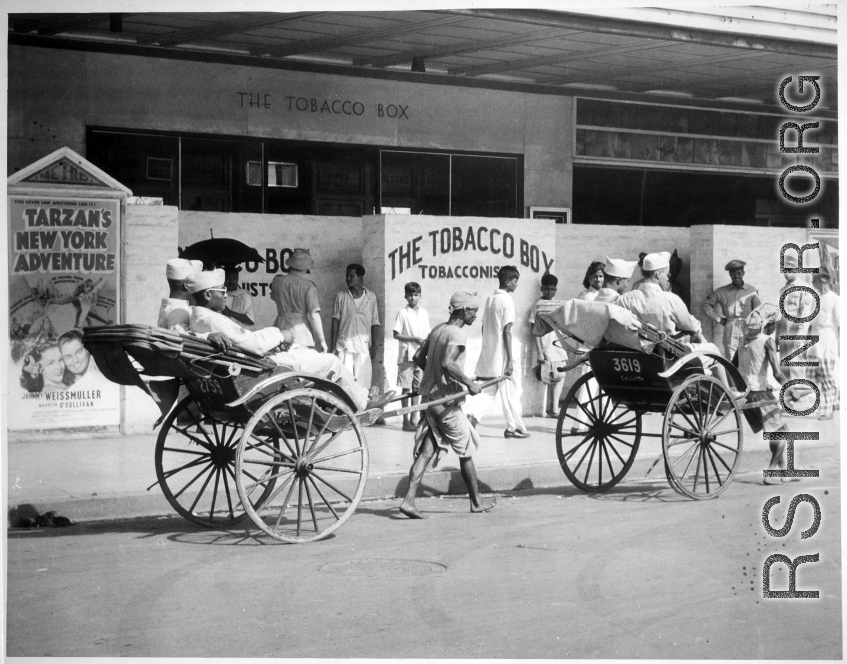 African-American GIs touring in India during WWII. "Rickshaws are almost as common in India as they are in China. Some of the...troops are on their way to see `Tarzan's New York Adventure'---in India..."