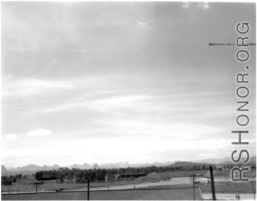 A view across part of American air base at Liuzhou in 1945, after being reoccupied by American and Chinese forces following Japanese withdrawal in 1945. Note apparent B-25 in tidy revetment, driving jeep, and ruins of base buildings, destroyed during Allied retreat, Japanese occupation, and again during Japanese withdrawal.