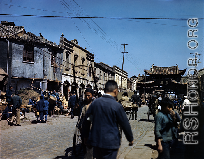 Street and markets near "Emerald Chicken" 碧鸡 and "Golden Horse" 金马 gates in Kunming during WWII, usually considered a pair: Golden Horse And Emerald Rooster Archway (金马碧鸡坊).  In the CBI during WWII.