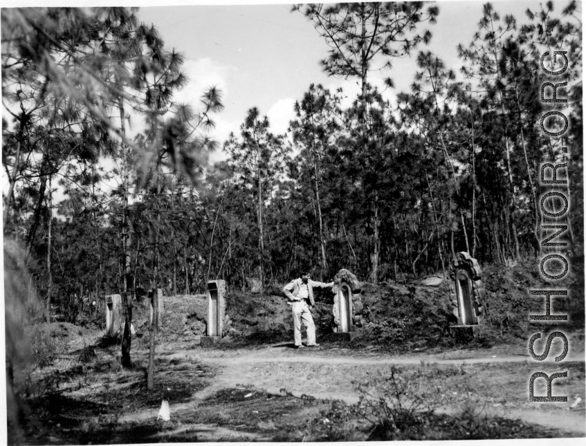 GI explorations of the hostel area at Yangkai air base during WWII: A GI looks at local graves.