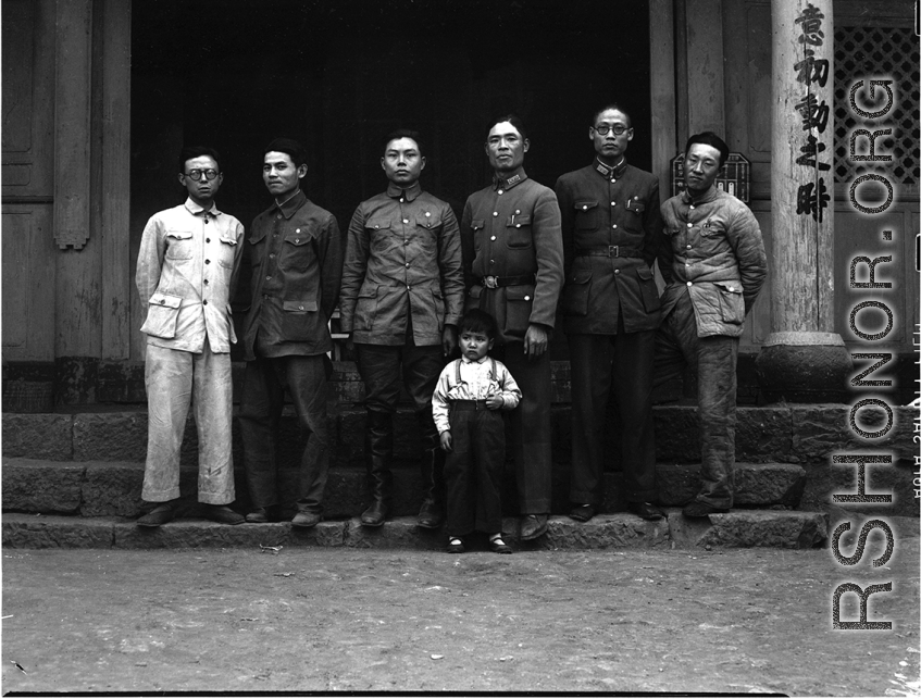 A group of local soldiers--likely a local militia or local KMT-affiliated warlord soldiers-- in Yunnan, China, during WWII. They are standing before a temple.