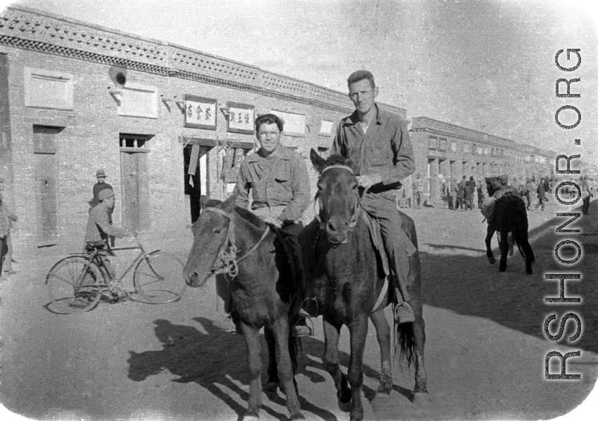 SACO men on mules on the street in Shaanba (陕坝镇), Inner Mongolia, China, during WWII.