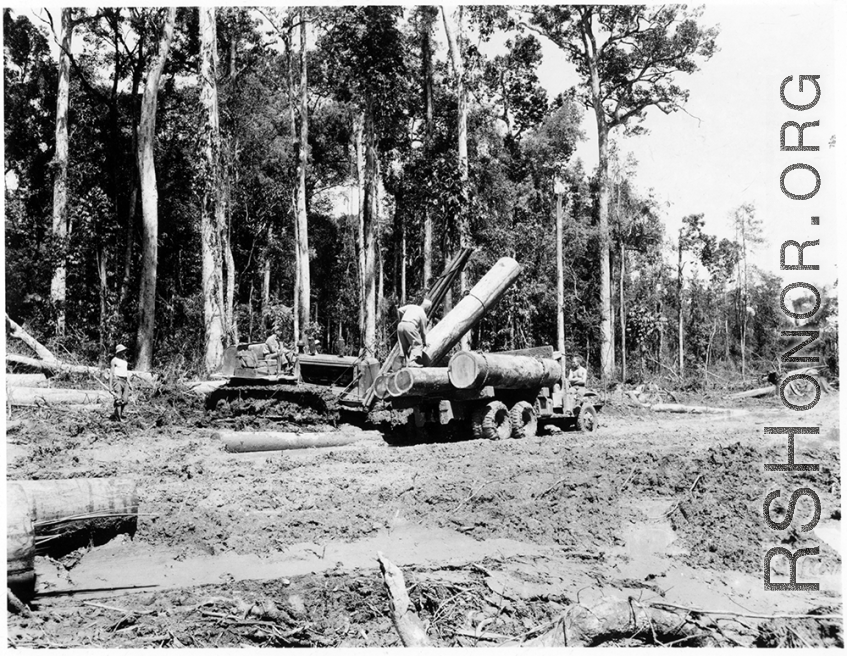 797th Engineer Forestry Company in Burma, loading logs for milling for bridge building along the Burma Road.  During WWII.