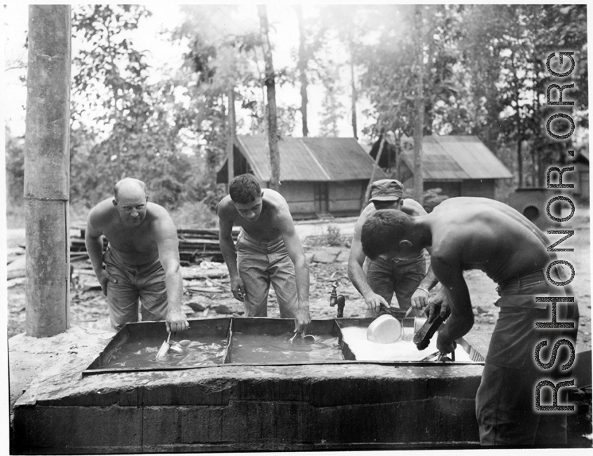 GIs of 797th Engineer Forestry Company washing their eating utensils in Burma.  During WWII.