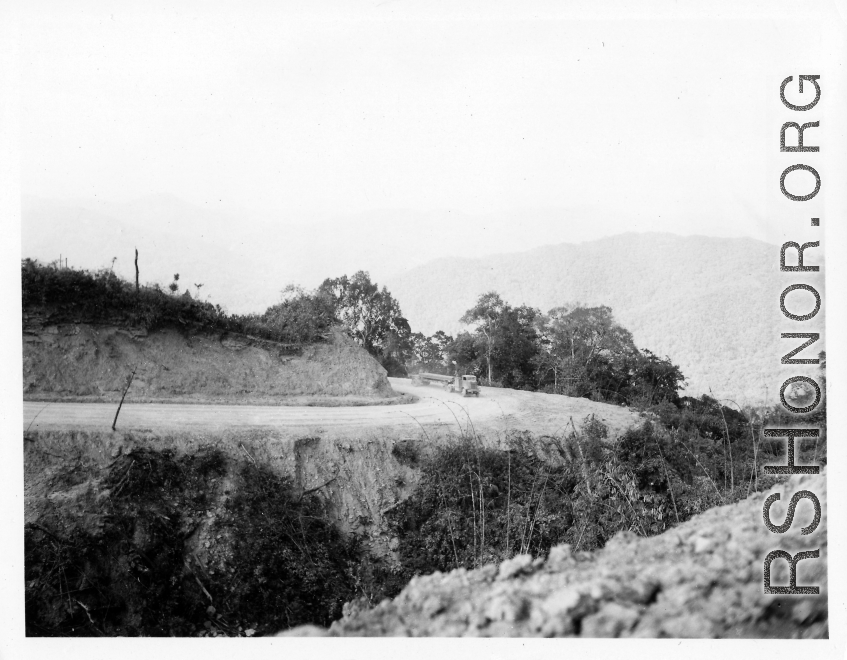 Truck carrying pipe on road in Burma.  During WWII.  797th Engineer Forestry Company.