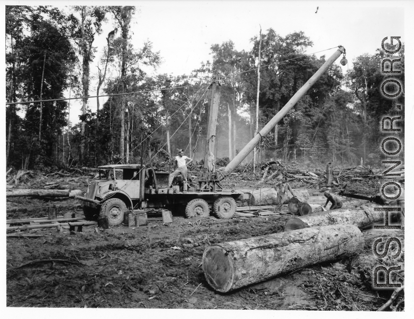 797th Engineer Forestry Company in Burma, loading logs for milling for bridge building along the Burma Road.  During WWII.