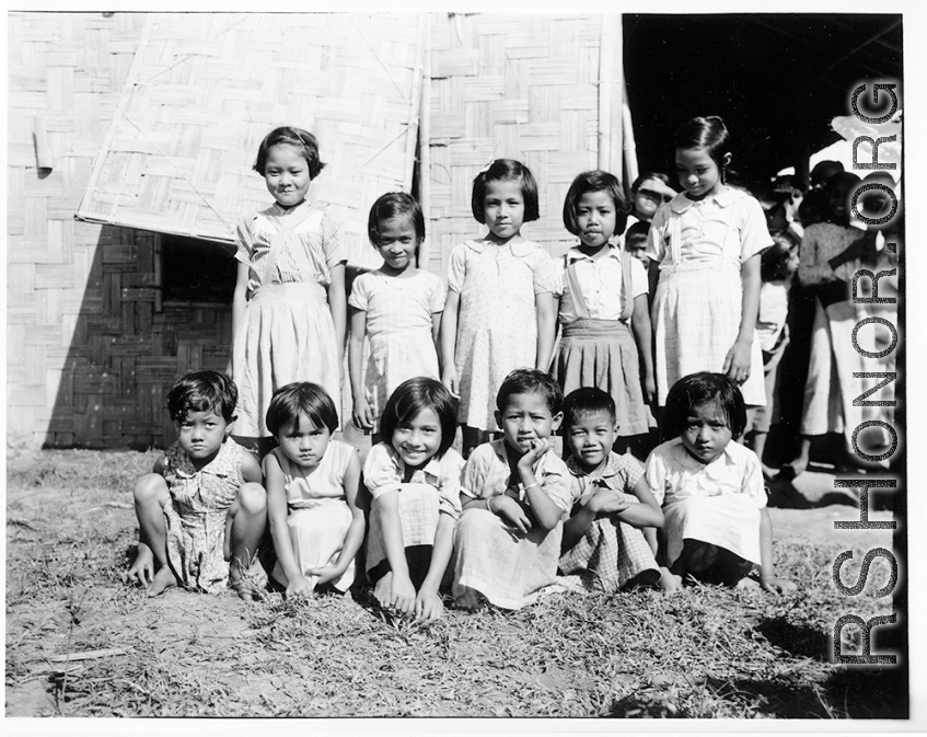 Local kids at a school (likely a missionary school) in Burma.  In Burma near the 797th Engineer Forestry Company.  During WWII.