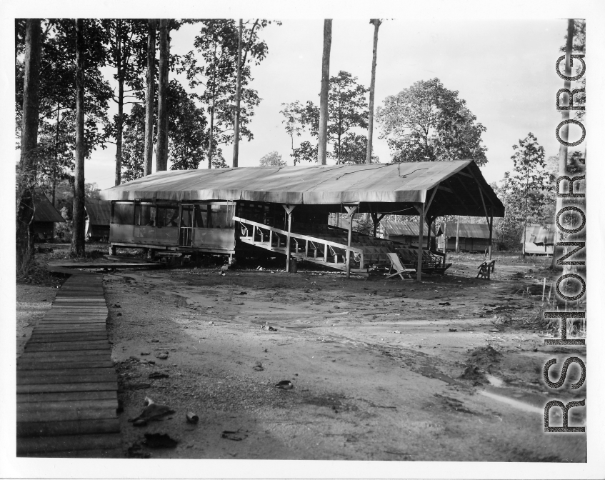 Jungle theater with raised wooden bleachers, covered, with open sides.  797th Engineer Forestry Company in Burma,  During WWII.