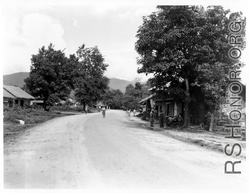 People on road in a village in Burma.  In Burma near the 797th Engineer Forestry Company.  During WWII.