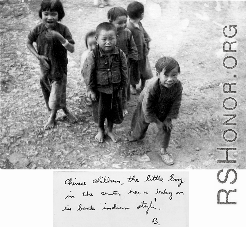 Chinese children, including one who is carrying a baby on his back. During WWII, in SW China.