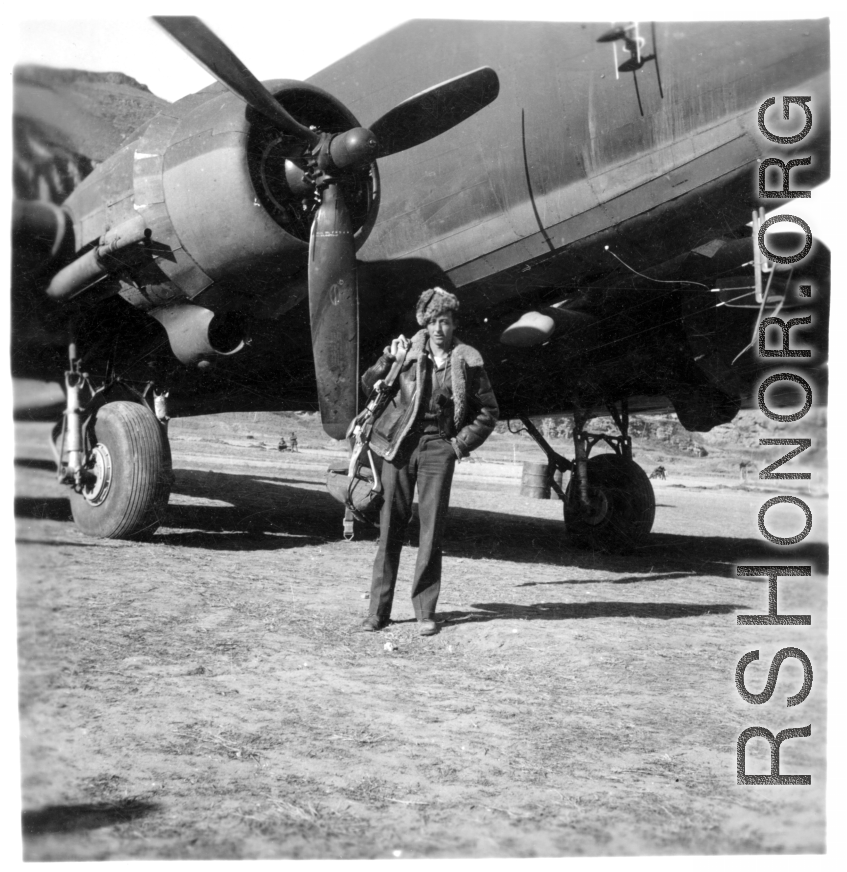 Photographer Edward Harold Dixon standing before a C-47 at a base in China, during WWII.