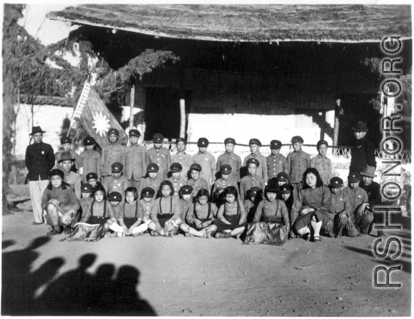 Local school kids pose in courtyard of school in Yunnan province, China, during WWII, at the Songming County Xiaogu Central Elementary School (嵩明县效古中心小学校).