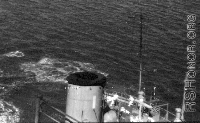 Near miss on a Japanese freighter, with white-suited Japanese sailors scrambling about the deck. From an October 16, 1944, mission on Hong Kong, 491st Bomb Squadron.