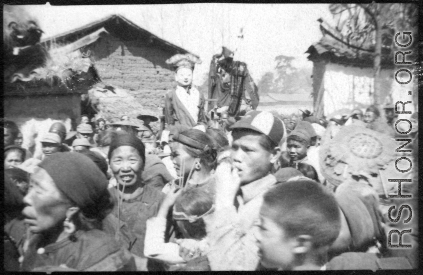 A village protective deity is paraded around the village as part of a festive celebration timed to the lunar calendar.  During WWII.