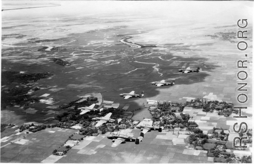 B-25s of the 22nd Bombardment Squadron in flight over rice paddies in SW China, French Indochina, or Burma during WWII.