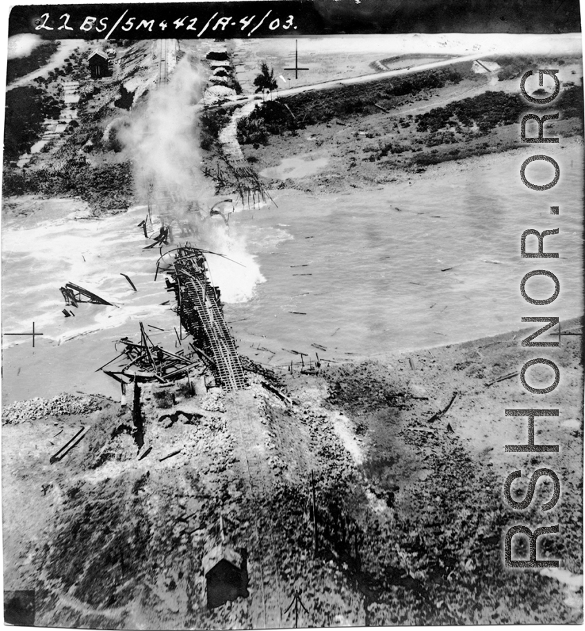 Aerial view of a railroad bridge just blown up by 22nd Bombardment Squadron in the CBI.