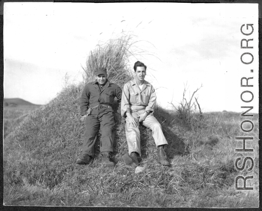 American flyers exploring at Chanyi (Zhanyi), during WWII. They are likely resting on a grave mound.