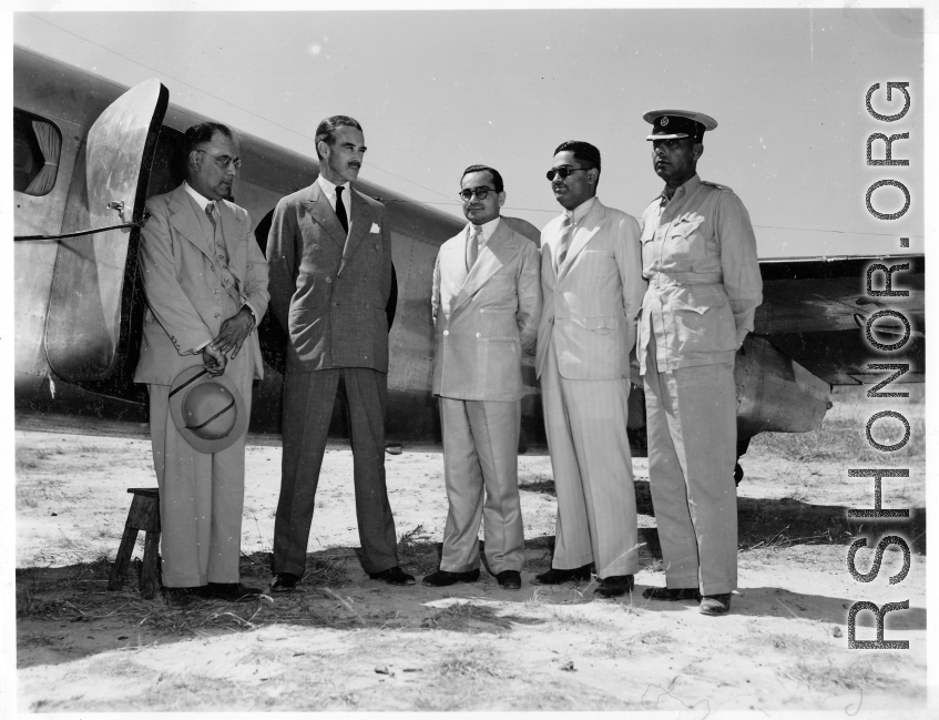 VIPs stand by airplane, likely in India.