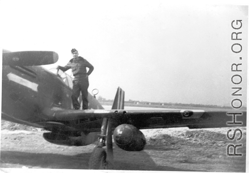 A flyer with a P-51 Mustang fighter, probably at an American air base in China. During WWII.  This appears to be Ernest W. Garner.