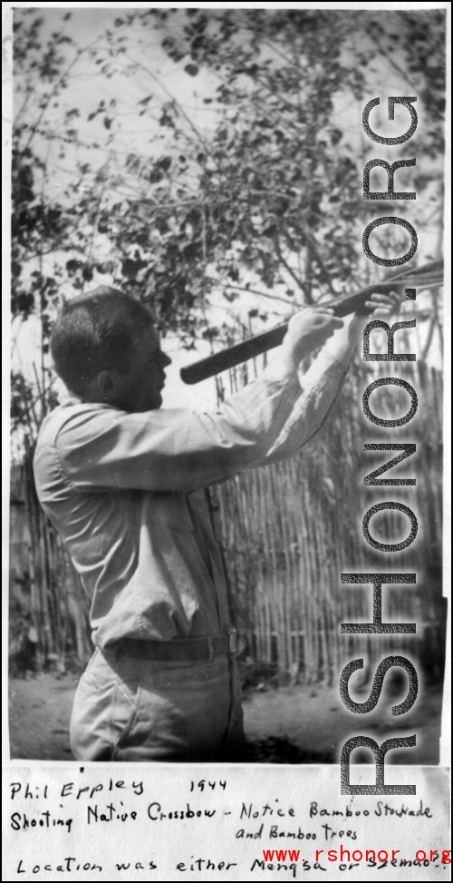 Phil Eppley shooting native crossbow in 1944, in Szemao or Mengsa, during WWII. Note native stockade of bamboo in the background. 