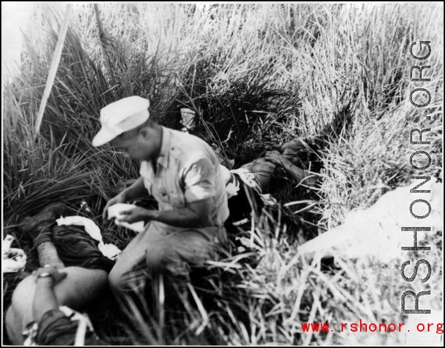 A medic attending to a victim of a bomb accidently exploding during a demonstration.