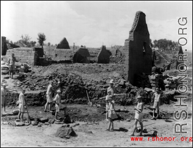 Chinese laborers working around destroyed houses, most likely in Yunnan province.