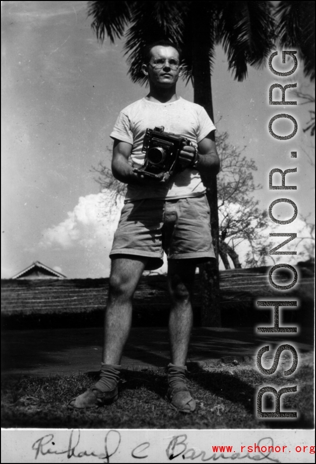 Richard C. Barnhard poses with camera in hand.  Photos taken by Robert F. Riese in or around Liuzhou city, Guangxi province, China, in 1945.