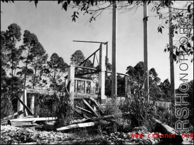 Bob Riese and friend explore remains of aircraft factory and hangers at the air base at Liuzhou, in 1945. The facilities at the base were first destroyed by the Chinese and Americans during retreat in the face of Ichigo during the fall of 1944, then may have been destroyed more by American bombardment during Japanese occupation, and possibly destroyed more by the Japanese as they retreated the area in 1945.