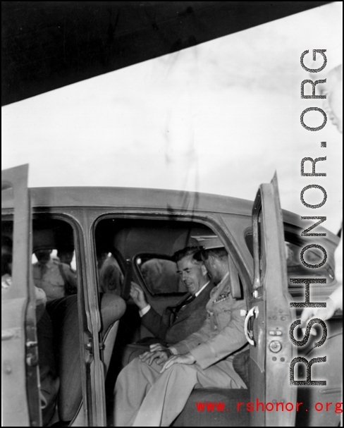 Chennault and an American VIP sit in a car in China during WWII.