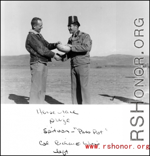 Col. Richard Wise (left) receives the prize--a spittoon "Piss-pot" at a horse race arranged at Guilin during WWII.