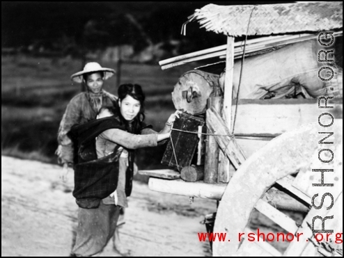Chinese refugees push a cart of possession in Guangxi province, China, during WWII, in the fall of 1944, as the Japanese advanced during the Ichigo campaign.