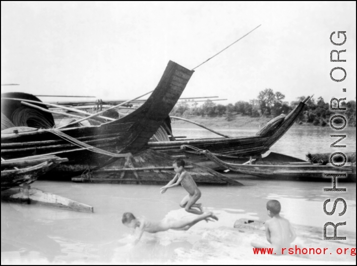 Kids swimming in a river in southern China during WWII.