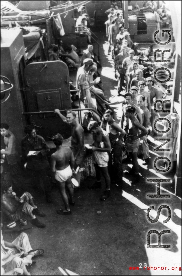 GIs line up for mess on ship on the way back to the US after the war. The ship is probably the SS Marine Raven.