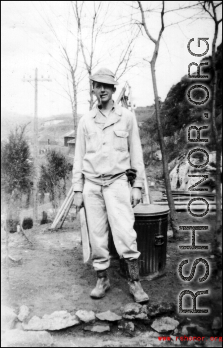 Douglas Runk holding a machete in SW China during WWII.