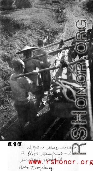 Chinese laborers carrying an American war dead draped in US flag. Near Tengchong, Yunnan, China. Williams notes that he had given blood donation for this soldier, but he had still not survived.  From the collection of Kenneth Williams.