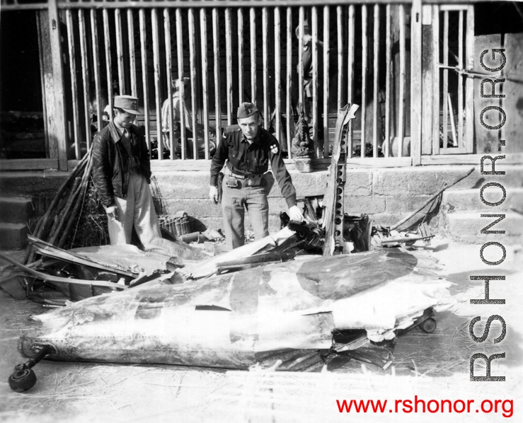 American and Chinese soldiers look over remains of a crashed Japanese airplane in the CBI during WWII.