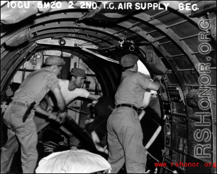 Men inside a US transport plane drop supplies from the air.10CU 6M20 2ND T.C. AIR SUPPLY SEC.