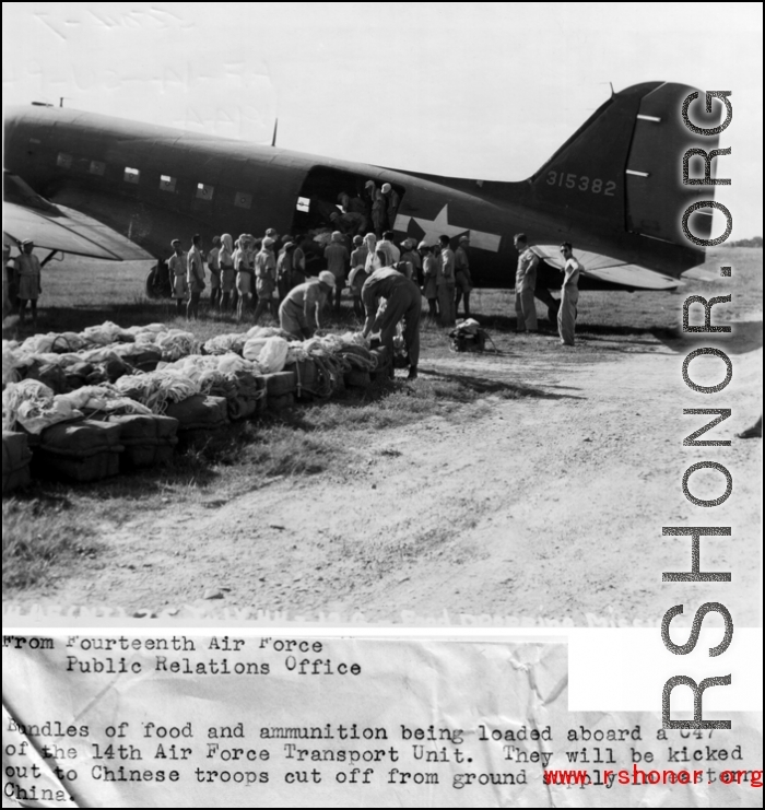 Bundles of food and ammunition being loaded aboard a C-47 of the 14th Air Force Transport Unit. They will be kicked out to Chinese troops cut off from ground supply in eastern China.