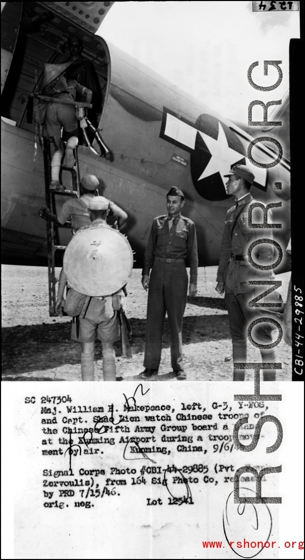 Maj. William H. Makepeace, left, G-3, Y-FOS, and Capt. Shao Lien watch Chinese troops of the Chinese Fifth Army Group board a plane at the Kunming Airport during a troopp movement by air.  Kunming, China, 9/69/44