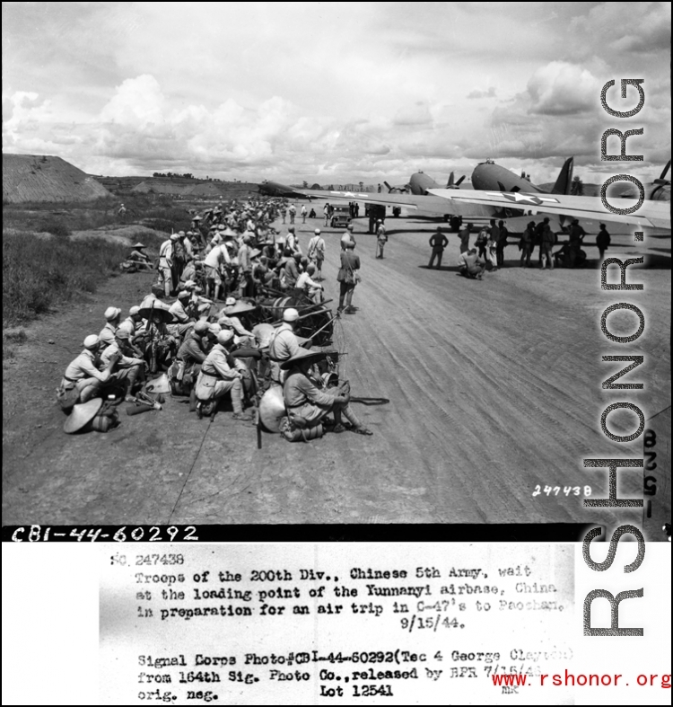 Troops of the 200th Div., Chinese 5th Army, wait at the loading point of the Yunnanyi airbase, China.