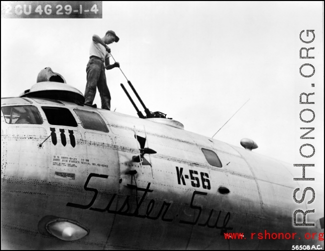 Sgt. Calvin Brown, Kimball, Minnesota, cleans the upper forward guns of the 20th Bomber Command Boeing B-29 Superfortress "Sister Sue".  China.  40th Bomb Group.