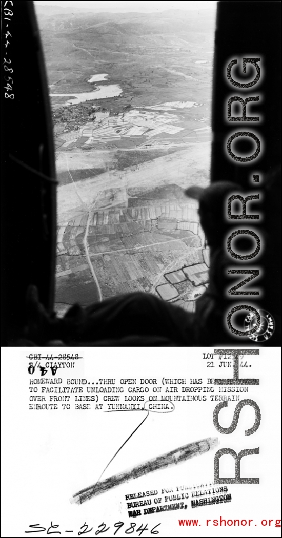 Homeward bound...through open door (which has been removed to facilitate unloading cargo on air dropping mission over front lines) crew look on mountainous terrain and rice paddies enroute to base at Yunnanyi, China.  Photo by T/4 Clayton, 21 June 1944