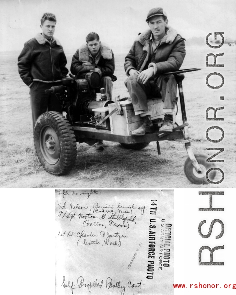 Three gentlemen, Ed Nelson (Bad Axe, Mich), Sgt. Norton G. Stubblefield (Dallas Texas), and 1st Lt. Charles J. Jantzen (Seattle, Washington) with the self-propelled battery cart they have built from spare parts and salvage.