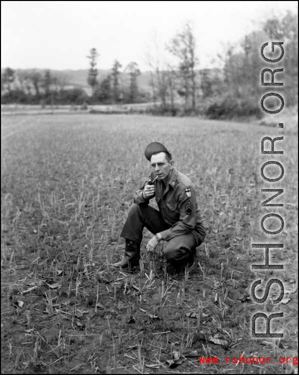 An American soldier in the CBI kneeling in a fallow rice paddy in China during WWII.