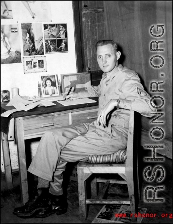 An American serviceman in the CBI writing at his desk in the barracks.  From the collection of Wozniak, combat photographer for the 491st Bomb Squadron, in the CBI.