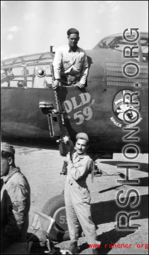 Eugene Montgomery passes a .50 cal machine gun up to Lloyd Kershaw, leaning out of the "green house" at Yangkai Airbase, China, in March 1944. They were preparing "Old '59'" for the beginning of its trip back to the USA where the the war weary B-25 and its original crew, from the 491st "Ringer Squadron" would tour on a War Bond drive.